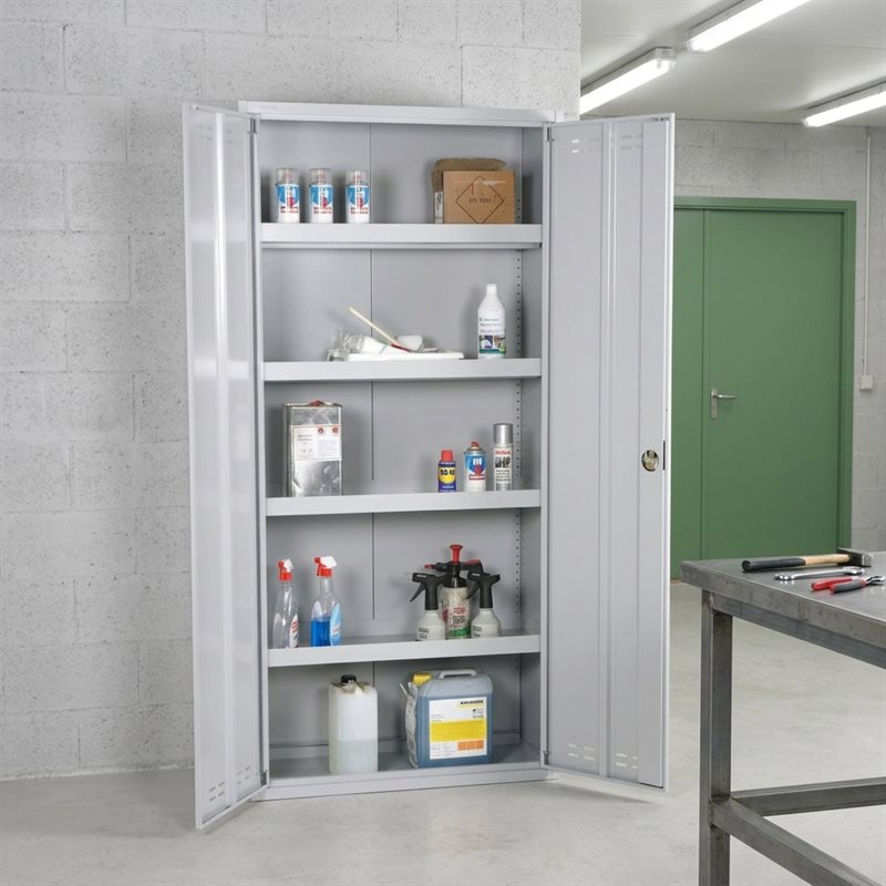 Grey metal cabinet with double open doors, filled with chemicals on shelves, in a warehouse.