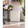 Light grey metal cabinet with key lock, cable pass-through and ventilation holes, door closed in office environment.
